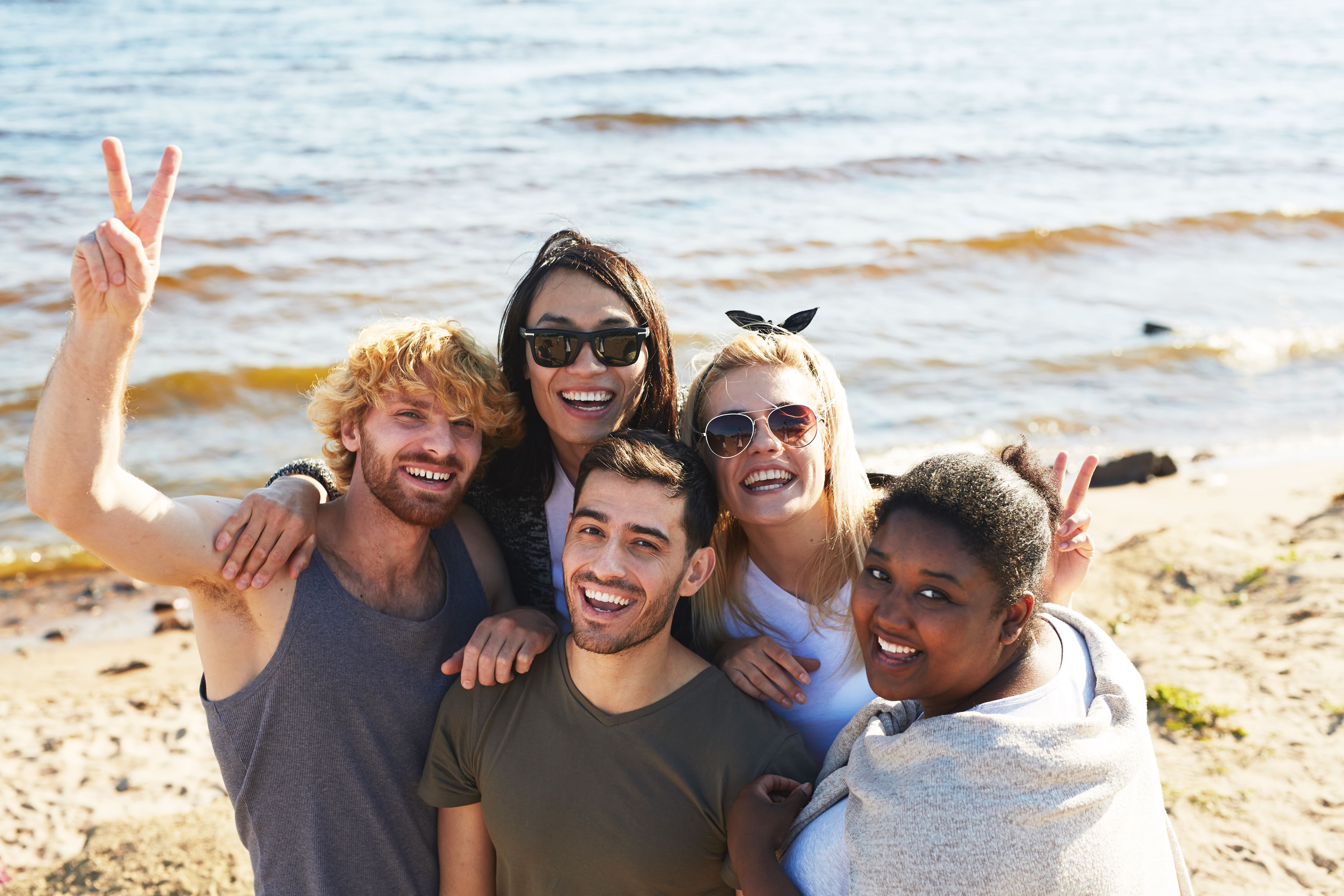 Five friends together at the beach