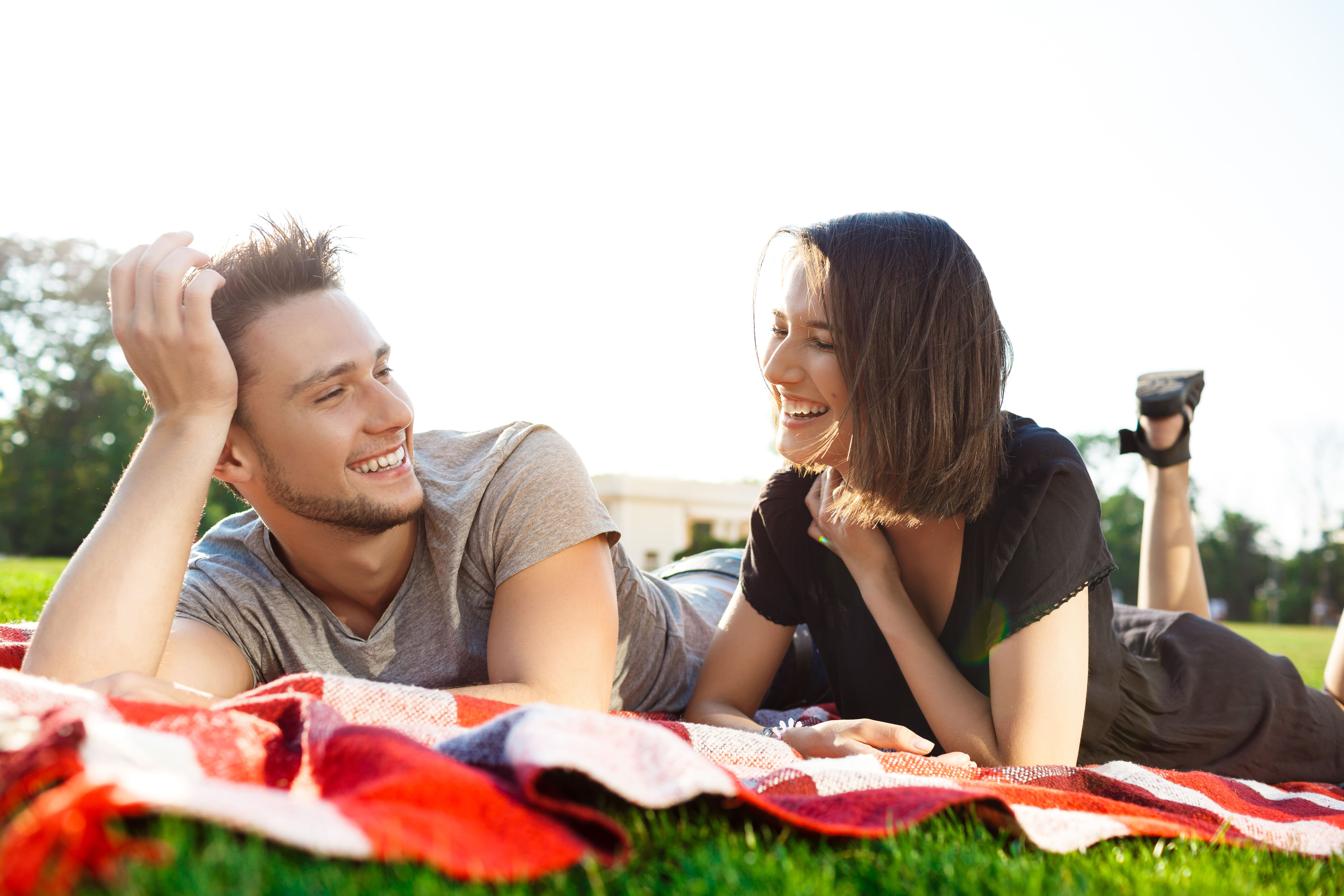 Couple smiling together during a picnic in the park